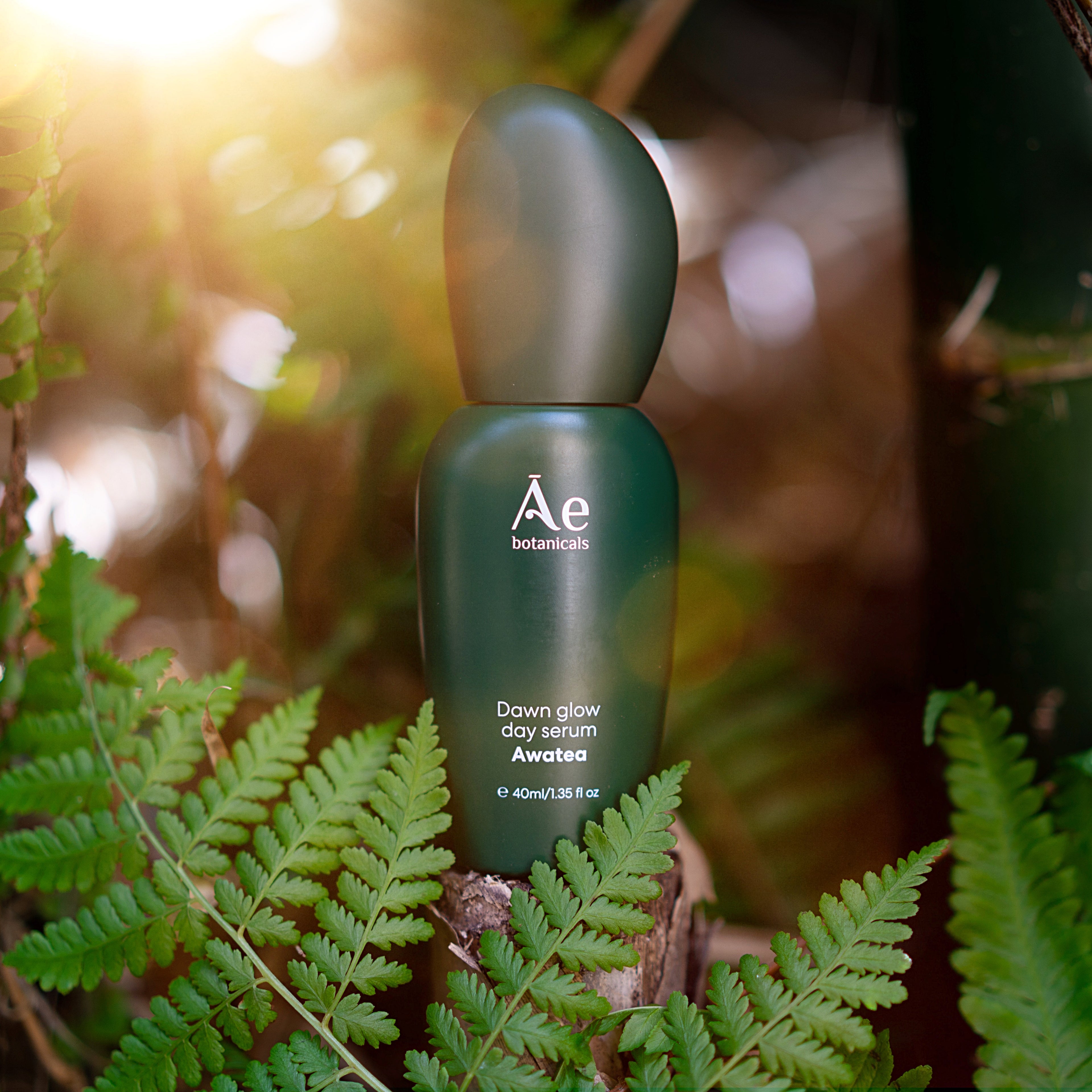 Green skincare serum bottle with &