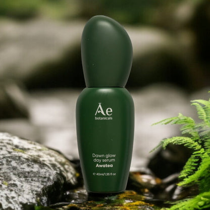 Green skincare serum bottle labeled &